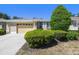A well-kept single-story home with an attached two-car garage and neatly trimmed bushes in the front yard at 4500 Golf Club Ln, Spring Hill, FL 34609