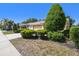 Cozy single-story home with a two-car garage and mature landscaping along the front walkway at 4500 Golf Club Ln, Spring Hill, FL 34609