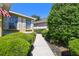 Charming home exterior with tidy landscaping, including shrubbery lining the walkway and windows at 4500 Golf Club Ln, Spring Hill, FL 34609