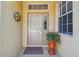 Front entrance featuring a decorative door, side window, an overhead window, plus a colorful decorative wall hanging at 4500 Golf Club Ln, Spring Hill, FL 34609