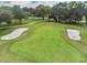 Scenic view of the lush golf course with manicured green and sand traps, showcasing a pristine landscape at 4500 Golf Club Ln, Spring Hill, FL 34609
