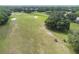 Panoramic view of a lush golf course with sand traps and mature trees, offering a serene and recreational landscape at 4500 Golf Club Ln, Spring Hill, FL 34609