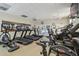 Fitness center equipped with treadmills, stationary bikes, and views of the community pool at 4500 Golf Club Ln, Spring Hill, FL 34609
