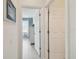 Bright hallway showcasing an open doorway to a bedroom with ample natural light and modern flooring at 4500 Golf Club Ln, Spring Hill, FL 34609