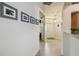 Hallway view showcasing hardwood floors that leads to the bright front entryway at 4500 Golf Club Ln, Spring Hill, FL 34609