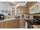 Kitchen featuring wooden cabinets, stainless appliances and solid surface counters at 4500 Golf Club Ln, Spring Hill, FL 34609