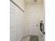 Functional laundry room with a full-size washer and dryer, closet, and storage space at 4500 Golf Club Ln, Spring Hill, FL 34609