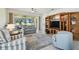 Cozy living room featuring a ceiling fan, a built in wooden entertainment center and sliding glass doors to the lanai at 4500 Golf Club Ln, Spring Hill, FL 34609