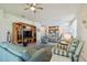 Open concept living space with striped furniture, and view to the kitchen and dining area at 4500 Golf Club Ln, Spring Hill, FL 34609