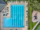Overhead view of the community pool area with lounge chairs, tables, and a separate pool at 4500 Golf Club Ln, Spring Hill, FL 34609