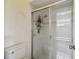 Bathroom featuring a tiled shower with glass doors at 4500 Golf Club Ln, Spring Hill, FL 34609