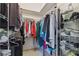 Spacious walk-in closet with shelving and hanging space for organized storage at 4500 Golf Club Ln, Spring Hill, FL 34609