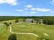 Aerial view of a golf course with lush green fairways and a grand clubhouse in the background at 4910 Southern Valley Loop, Brooksville, FL 34601