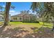 Private backyard featuring a screened patio and mature landscaping at 4910 Southern Valley Loop, Brooksville, FL 34601