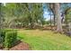 Lush backyard view with mature trees and a privacy fence at 4910 Southern Valley Loop, Brooksville, FL 34601