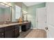 Bathroom features dual sinks, dark cabinets, and a framed mirror at 4910 Southern Valley Loop, Brooksville, FL 34601