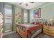 Cozy bedroom featuring natural light, stylish decor, and wood-look flooring at 4910 Southern Valley Loop, Brooksville, FL 34601