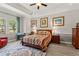 Spacious bedroom showcases large windows, an accent rug, and decorative artwork at 4910 Southern Valley Loop, Brooksville, FL 34601