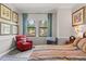 Bedroom featuring a comfortable chair, bright windows, and decorative wall art at 4910 Southern Valley Loop, Brooksville, FL 34601
