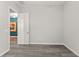 Empty bedroom showcasing modern flooring and a view into an adjoining room at 4910 Southern Valley Loop, Brooksville, FL 34601
