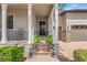 Welcoming front porch with decorative columns, stone accents, potted plants, and brick stairs leading to the entrance at 4910 Southern Valley Loop, Brooksville, FL 34601
