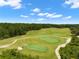 Aerial view of golf course, showcasing lush green fairways and challenging sand traps at 4910 Southern Valley Loop, Brooksville, FL 34601