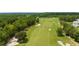 Scenic aerial view of a lush golf course with manicured greens and surrounding trees at 4910 Southern Valley Loop, Brooksville, FL 34601