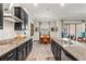 Stylish kitchen includes granite countertops, stainless steel appliances, and black cabinetry at 4910 Southern Valley Loop, Brooksville, FL 34601