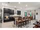 Open-concept kitchen includes a center island with barstool seating and black cabinets at 4910 Southern Valley Loop, Brooksville, FL 34601