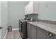 Functional laundry room with modern washer and dryer, ample counter space, and storage cabinets at 4910 Southern Valley Loop, Brooksville, FL 34601