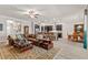 Open-concept living room seamlessly connects to the kitchen and dining areas with dark cabinets at 4910 Southern Valley Loop, Brooksville, FL 34601