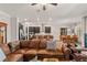 An inviting open-plan living area featuring a leather couch and views of the kitchen at 4910 Southern Valley Loop, Brooksville, FL 34601