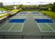 Aerial view of outdoor pickleball courts with blue and green surface and black fencing at 4910 Southern Valley Loop, Brooksville, FL 34601