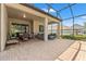A covered, screened patio with brick floors, ample seating, and views of the backyard at 4910 Southern Valley Loop, Brooksville, FL 34601