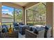 Cozy screened patio featuring comfortable seating and a covered fire pit at 4910 Southern Valley Loop, Brooksville, FL 34601