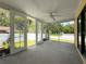 Back porch with ceiling fan and view of fenced backyard at 5147 Larch Ln, New Port Richey, FL 34653