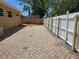 Backyard features a white fence and brick ground at 5147 Larch Ln, New Port Richey, FL 34653