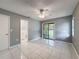 Bedroom with tile flooring, ceiling fan, closet, and bathroom access at 5147 Larch Ln, New Port Richey, FL 34653