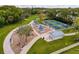 A beautiful community park with a playground, picnic area, pickleball courts, and walking trails surrounded by mature trees at 5147 Larch Ln, New Port Richey, FL 34653