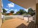 Cozy front porch with wood deck and white picket fence offers a welcoming entrance to the home at 5147 Larch Ln, New Port Richey, FL 34653