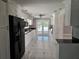 Kitchen featuring tile floors, granite countertops, white cabinets, and stainless steel appliances at 5147 Larch Ln, New Port Richey, FL 34653
