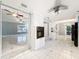 Modern kitchen showcasing white cabinetry, dark countertops, and open layout to the living area at 5147 Larch Ln, New Port Richey, FL 34653