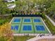 Overhead view of fenced pickleball and basketball courts, perfect for enjoying a game with friends and neighbors at 5147 Larch Ln, New Port Richey, FL 34653