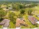 Expansive aerial view of a home with a screened pool, a golf course view, and lush landscaping at 5164 Golf Club Ln, Spring Hill, FL 34609