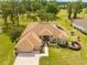 Beautiful home featuring mature landscaping, a screened pool, and a brick paver driveway and entryway at 5164 Golf Club Ln, Spring Hill, FL 34609