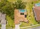 Aerial view of the house with a screened-in pool and well-maintained landscaping at 5164 Golf Club Ln, Spring Hill, FL 34609