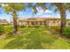 Expansive backyard showcasing lush green lawn and a screened-in pool area at 5164 Golf Club Ln, Spring Hill, FL 34609