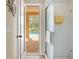 Bathroom with glass shower and outdoor access to a brick patio and pool at 5164 Golf Club Ln, Spring Hill, FL 34609