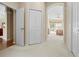 Hallway view into the Primary bedroom with white carpet and closet at 5164 Golf Club Ln, Spring Hill, FL 34609