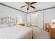 Inviting bedroom featuring a ceiling fan and double doors leading to another room at 5164 Golf Club Ln, Spring Hill, FL 34609